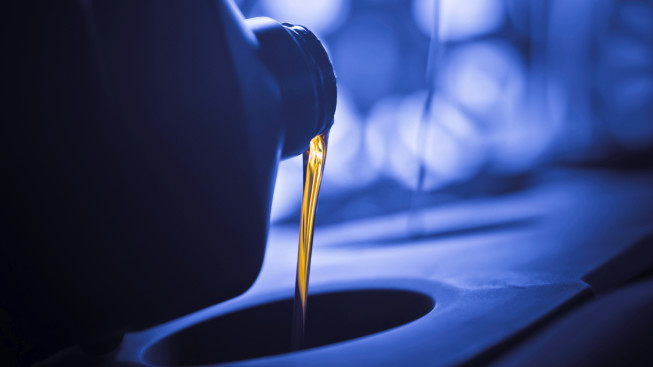 Pouring oil into machine